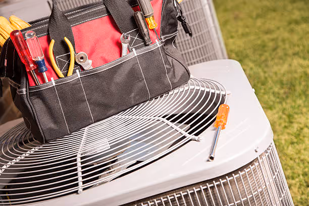 Tool bag on air conditioning unit with tools ready for HVAC repair