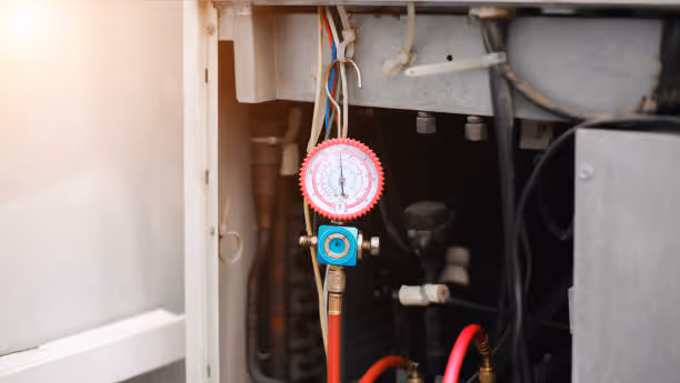 Pressure gauge connected to machinery with electrical wires and pipes
