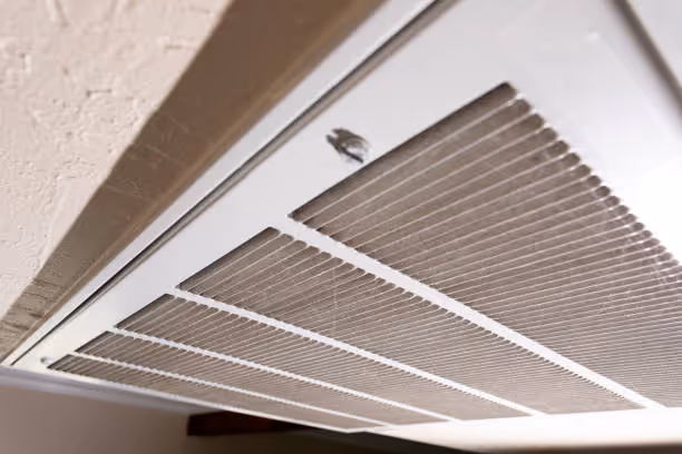 Close-up of a white air vent or return with horizontal metal slats