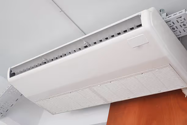 White wall-mounted air conditioning unit in a modern interior