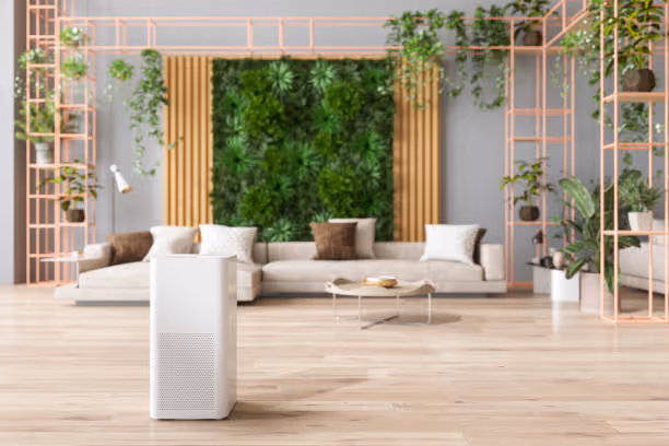 Modern living room with green wall, plants, sofa, and air purifier