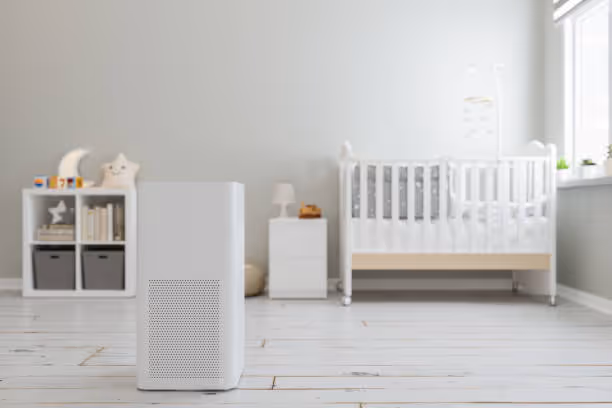 Minimalist nursery with white crib, air purifier, and shelf with decorative items