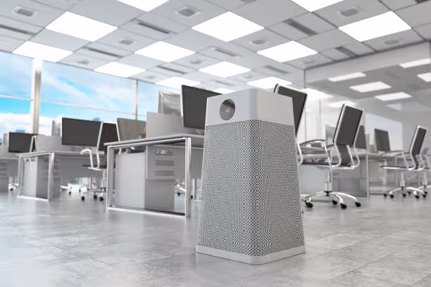 Modern office interior with air purifier, computers, and bright lighting