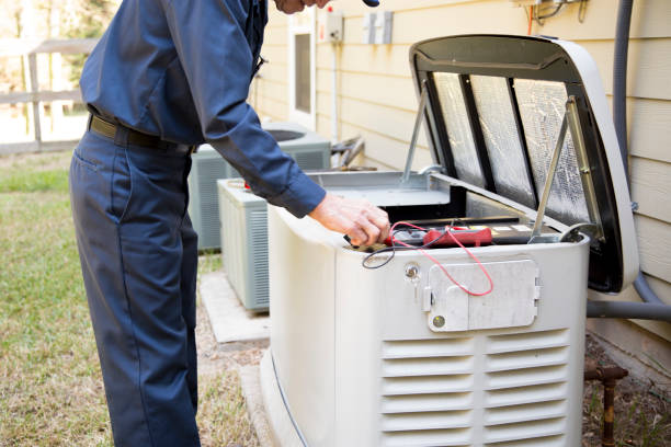 Technician checking electrical connections on an outdoor generator