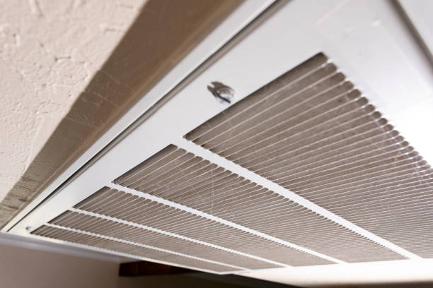 Close-up of white and gray air return vent with parallel metal slats