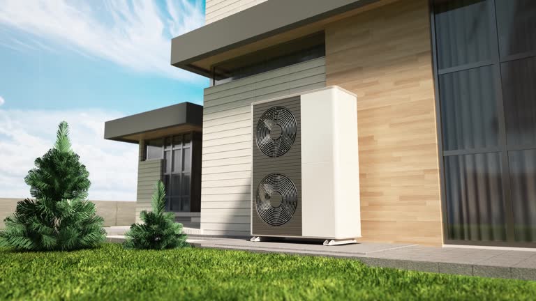 Modern heat pump installed outside energy-efficient home with landscaped yard