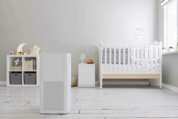Minimalist nursery with white crib, air purifier, and decorative shelf