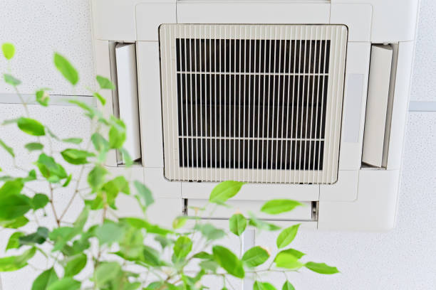 Air conditioning unit with green leaves, symbolizing fresh and clean air
