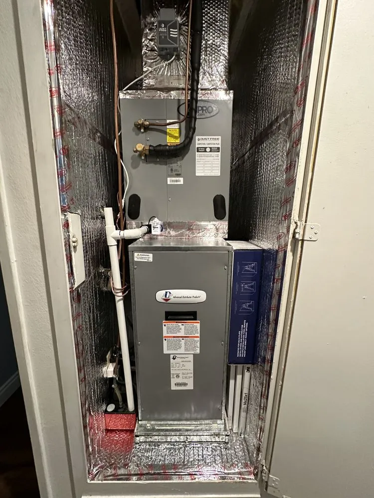 HVAC air handler unit installed in metallic insulated closet space