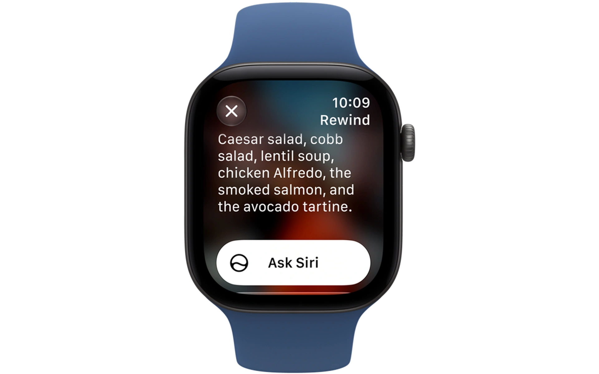 Apple Watch mit blaustrukturiertem Armband zeigt das Siri-Interface mit Diktat-Text zu Gerichten wie Salaten und Suppen.