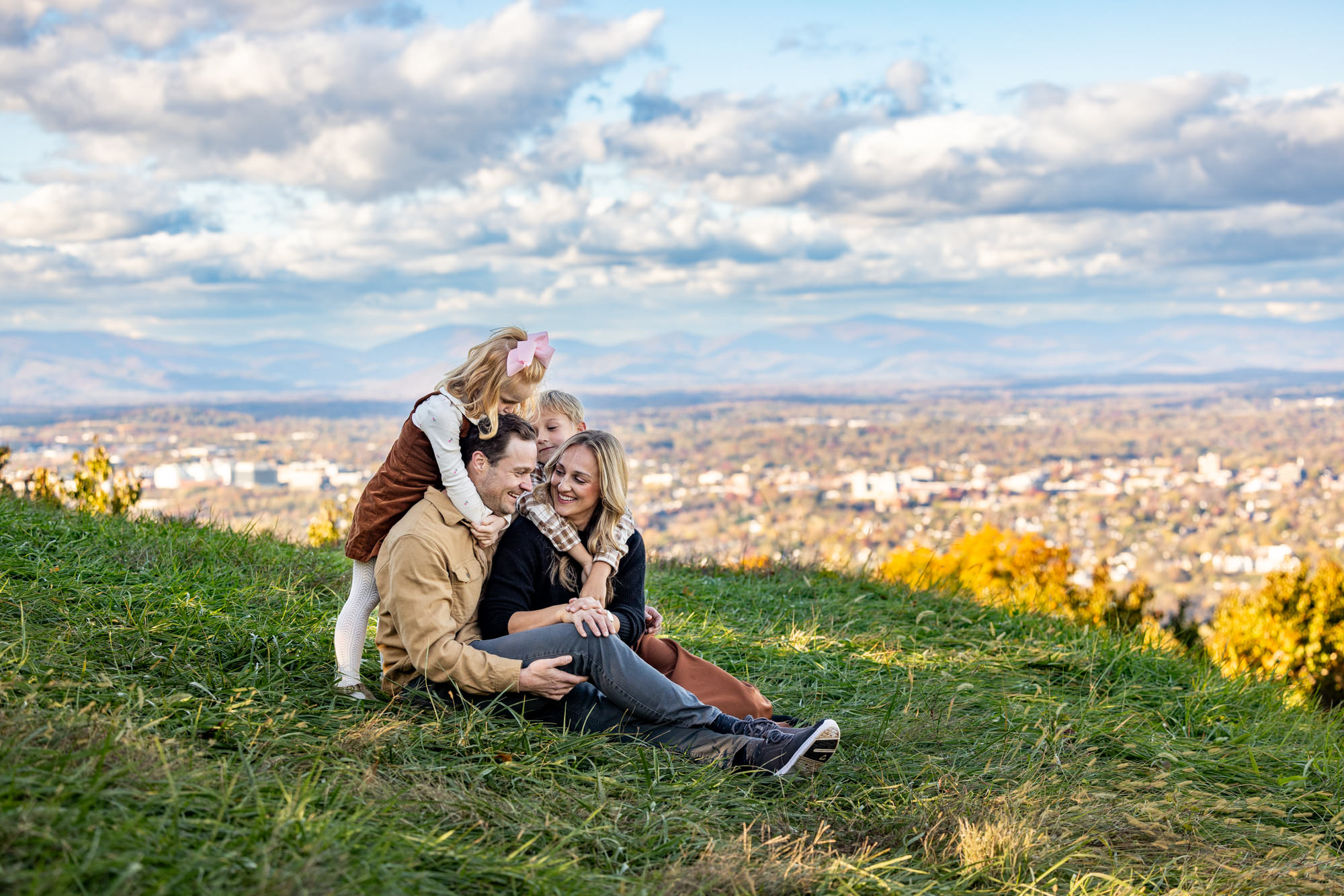 A family poses for their portrait at Carter's Mountain Overlook in Charlottesville, Virginia during the fall