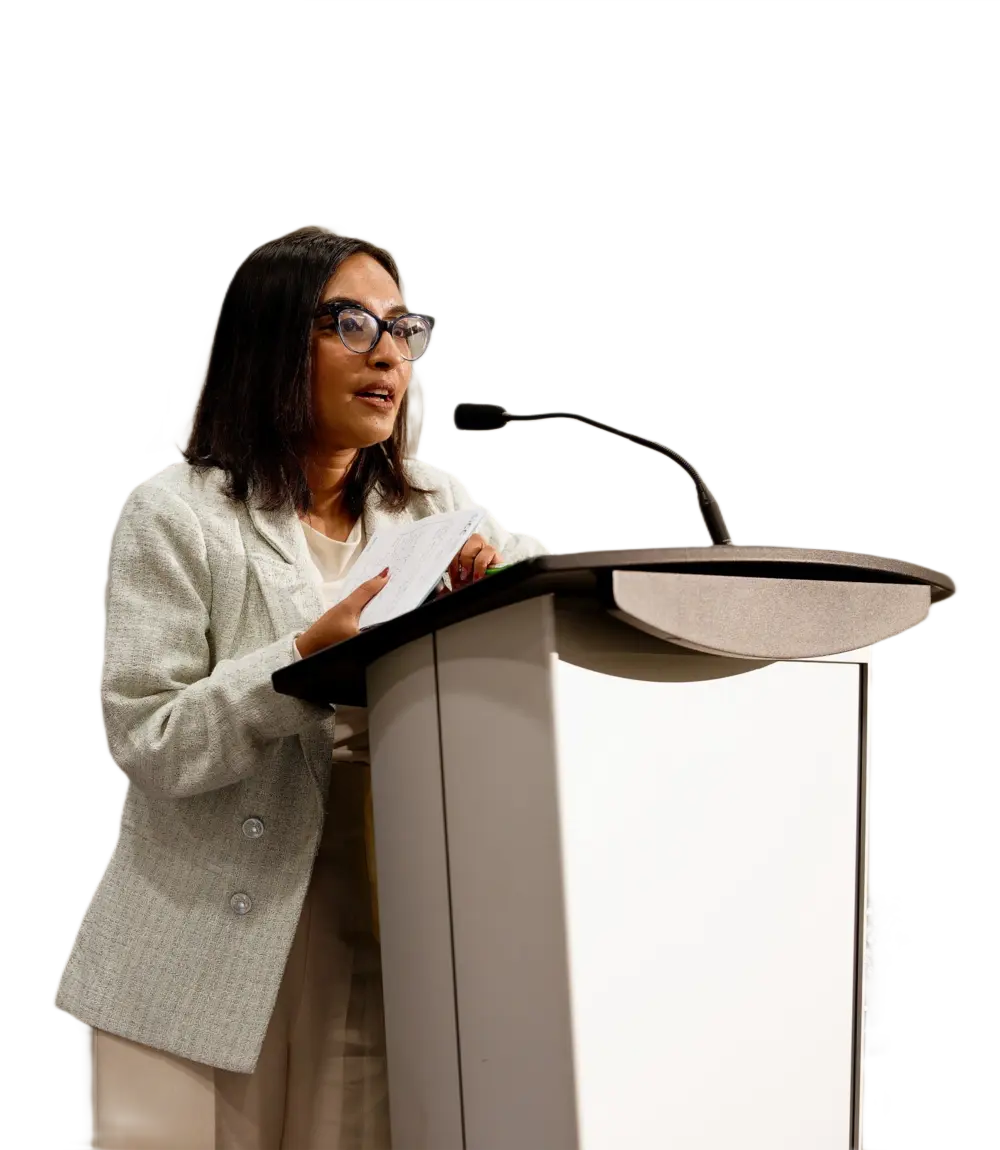 CogniCo CEO Mehnaz Tabassum standing before a podium