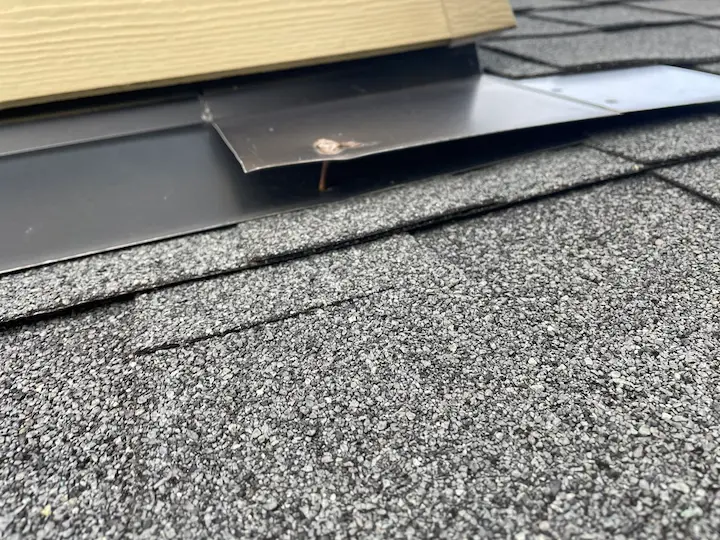 Loose flashing around skylight.