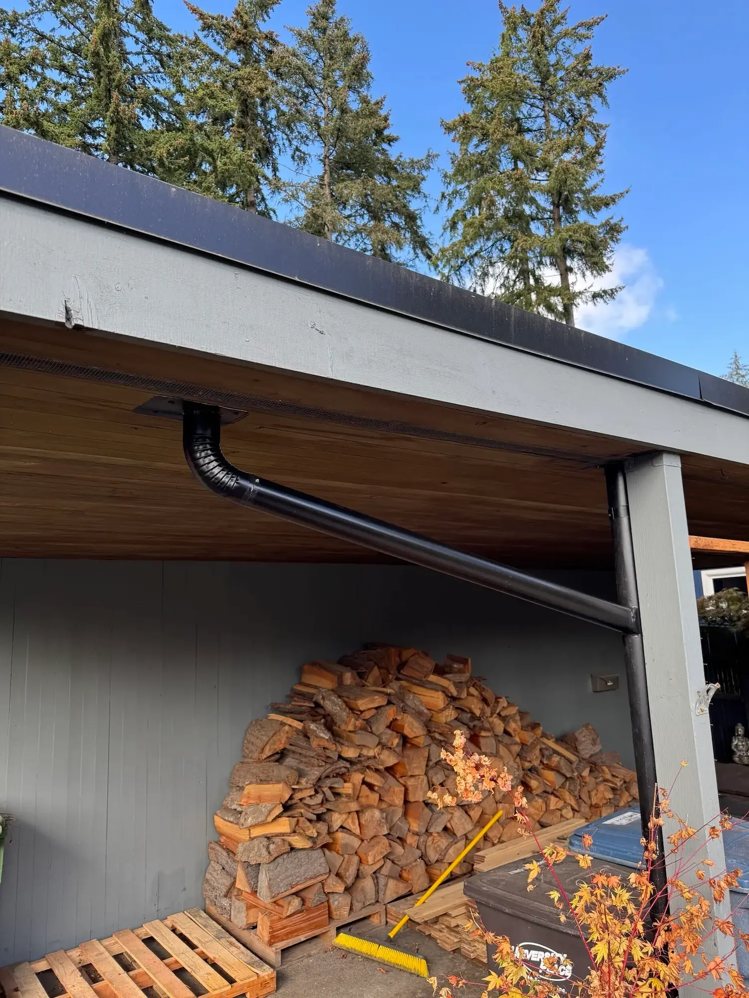 New downspout drainage system installed by Flat Roof Pros roofing contractor.