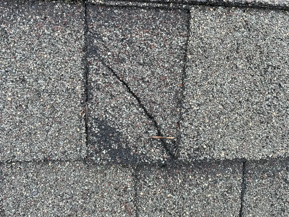 Damage crack on shingle roof.