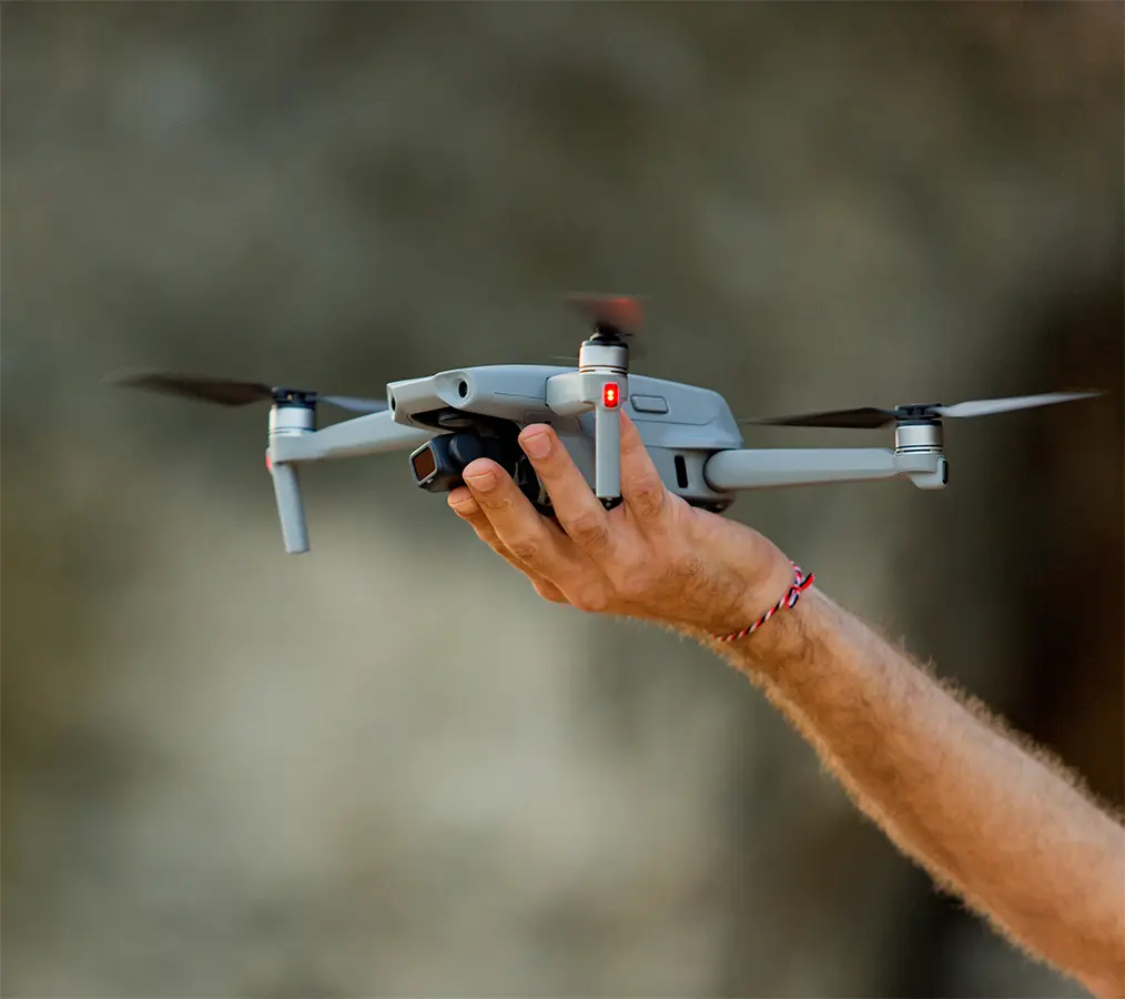 Flat Roof Pros NW preparing a drone to survey a commercial roof and record QC progress for the client portal.