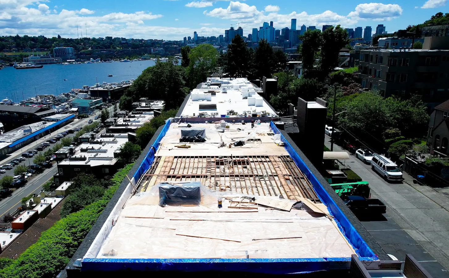 Flat Roof Pros NW phasing the install—deck demo, materials staged, and perimeter protections to keep the building dry while we work.