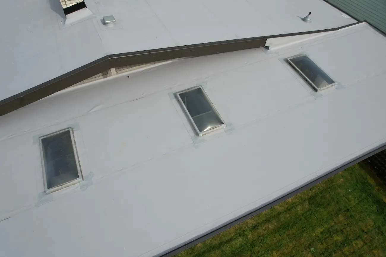 Close-up view of newly installed TPO around skylights, showing precise flashing and airtight waterproofing
