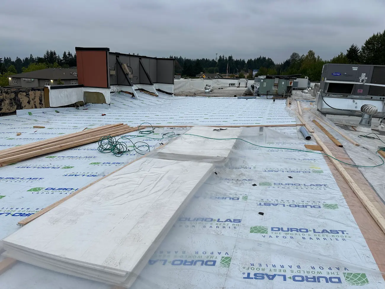 Duro-Last vapor barrier installation in progress on commercial flat roof during major hotel roofing project in Washington