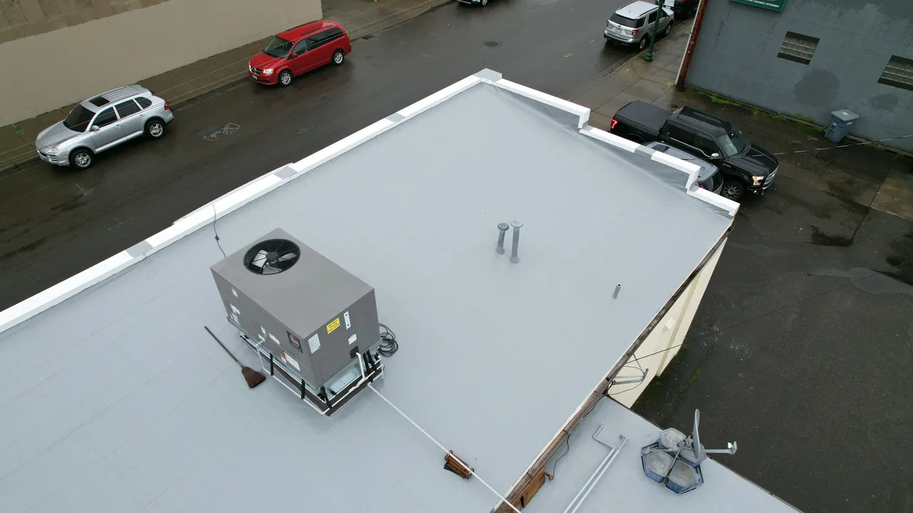 Completed commercial flat roof with rooftop heating and cooling equipment.