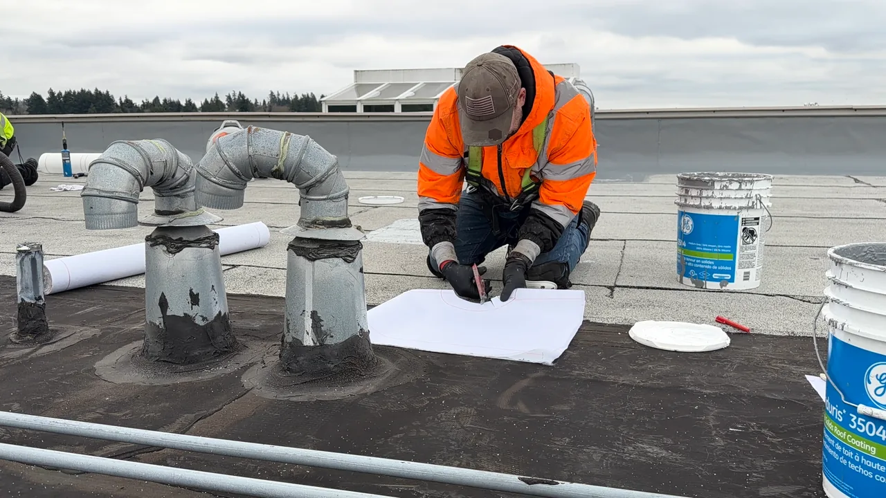 Flat Roof Pros technician completing a detailed permanent repair around a roof penetration.
