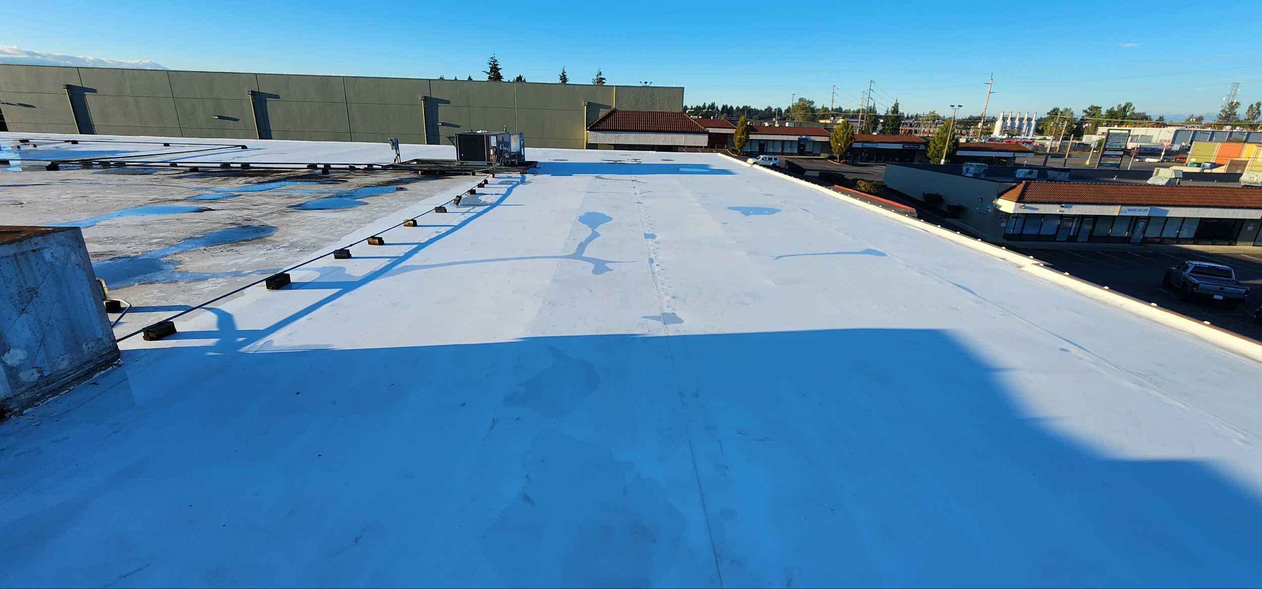 Commercial flat roof being evaluated and prepared for a silicone restoration coating