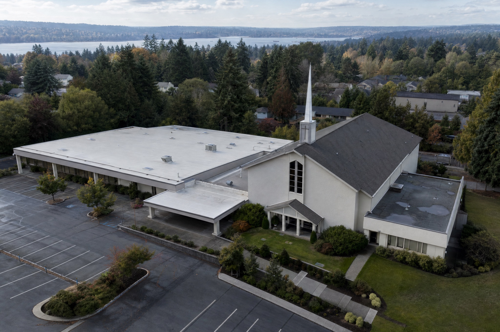 Aerial view of a Christian church property with sanctuary and low-slope roof sections