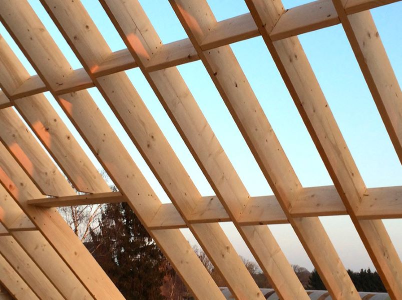 Nieuwe houten dakconstructie met kepers en gordingen voor een hellend dak.
