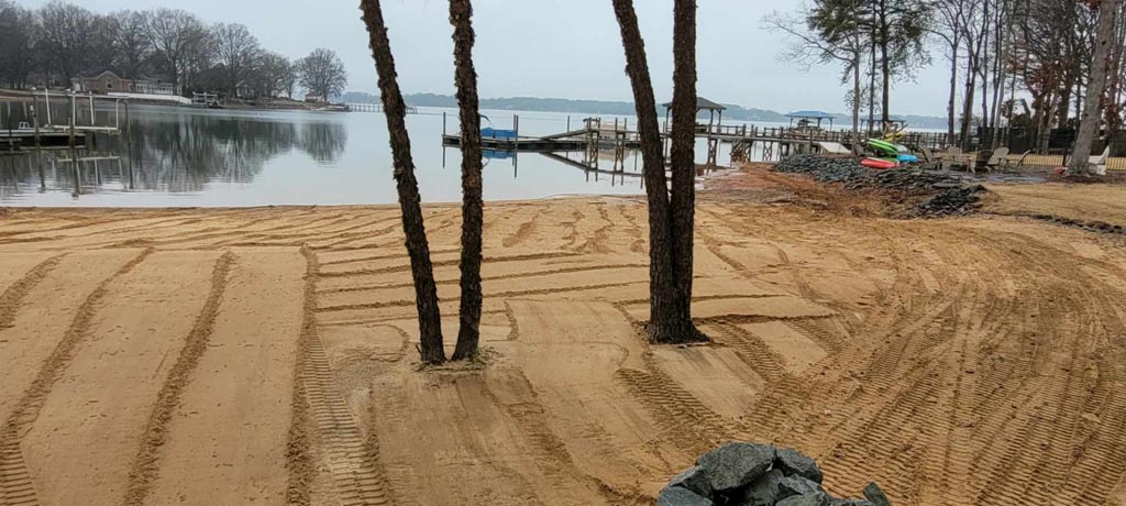 A shoreline lot being cleaned and professionally graded.