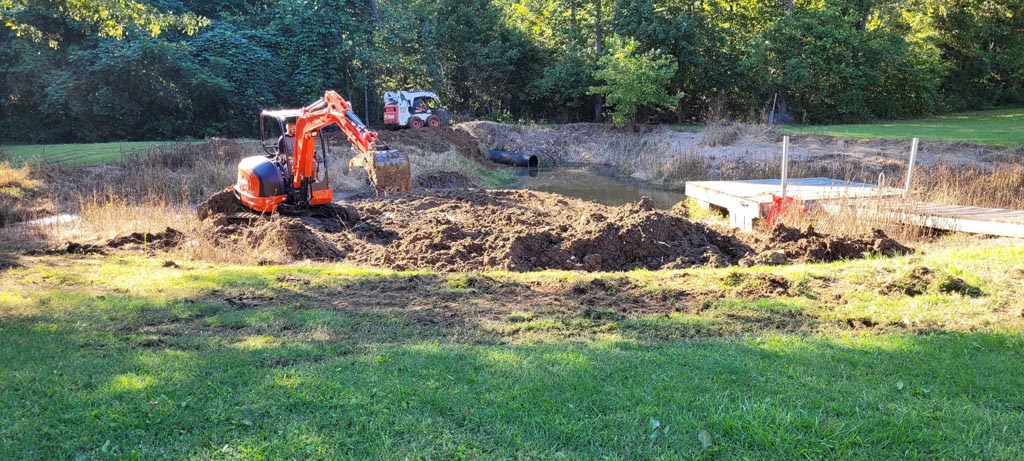 Digging out and extending an existing pond.