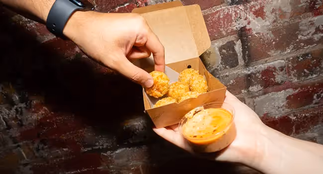 BurgerFuel Nitro Nibbles: spicy jalapeño, cheese, and corn bites in a crispy crumb, served with Chipotle Aioli. 