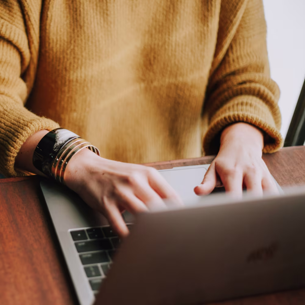 woman typing on a laptop