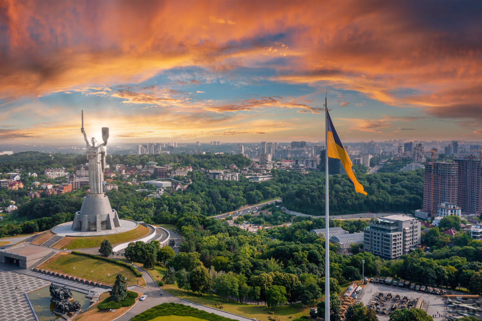 Panorama of Kiev hills with a flag and a monument