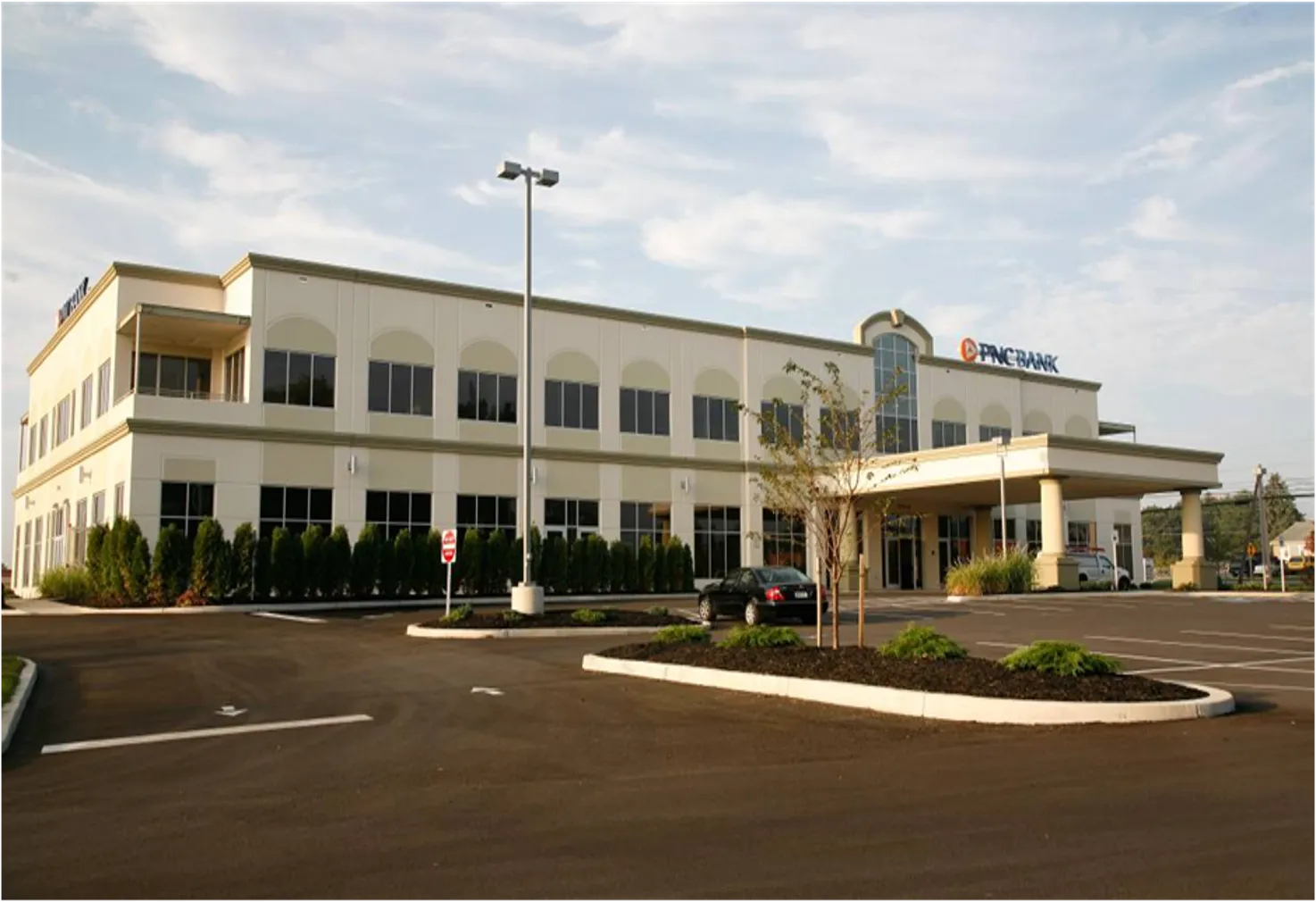 PNC Bank building features a modern design with landscaped parking and clear signage.
