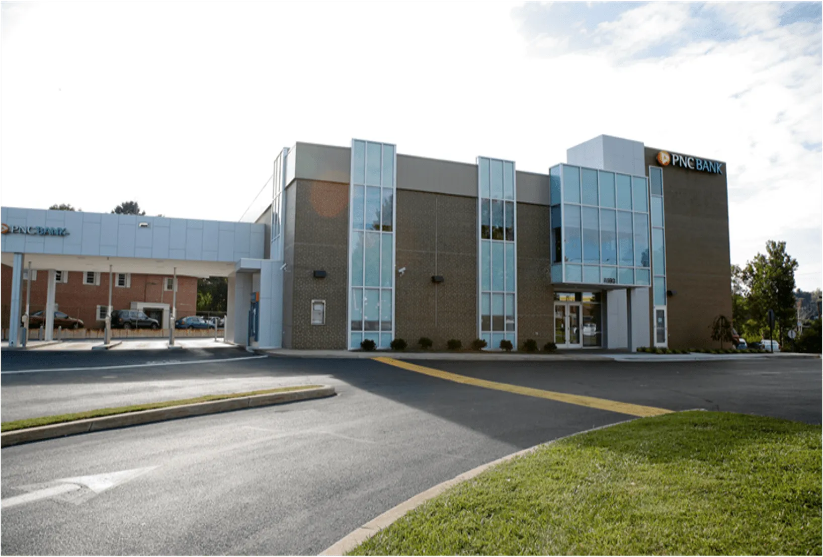 Pine Bank's modern building features large windows and a convenient drive-thru for customer service.
