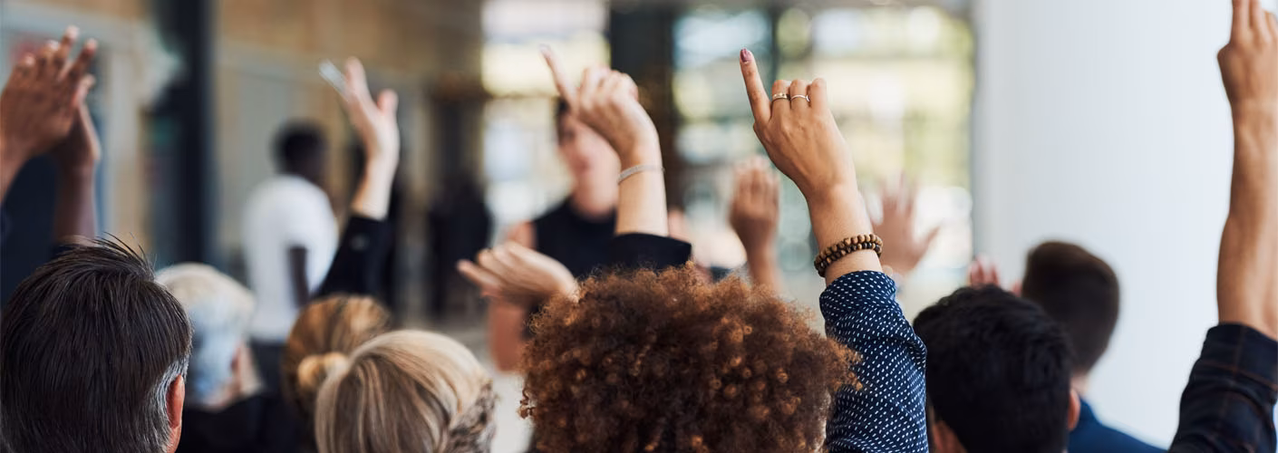 An image of people holding up their hands