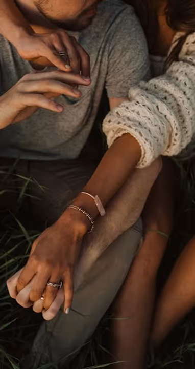 Young couple observed from top hugging with man side-front and her hands over his back-shoulders.