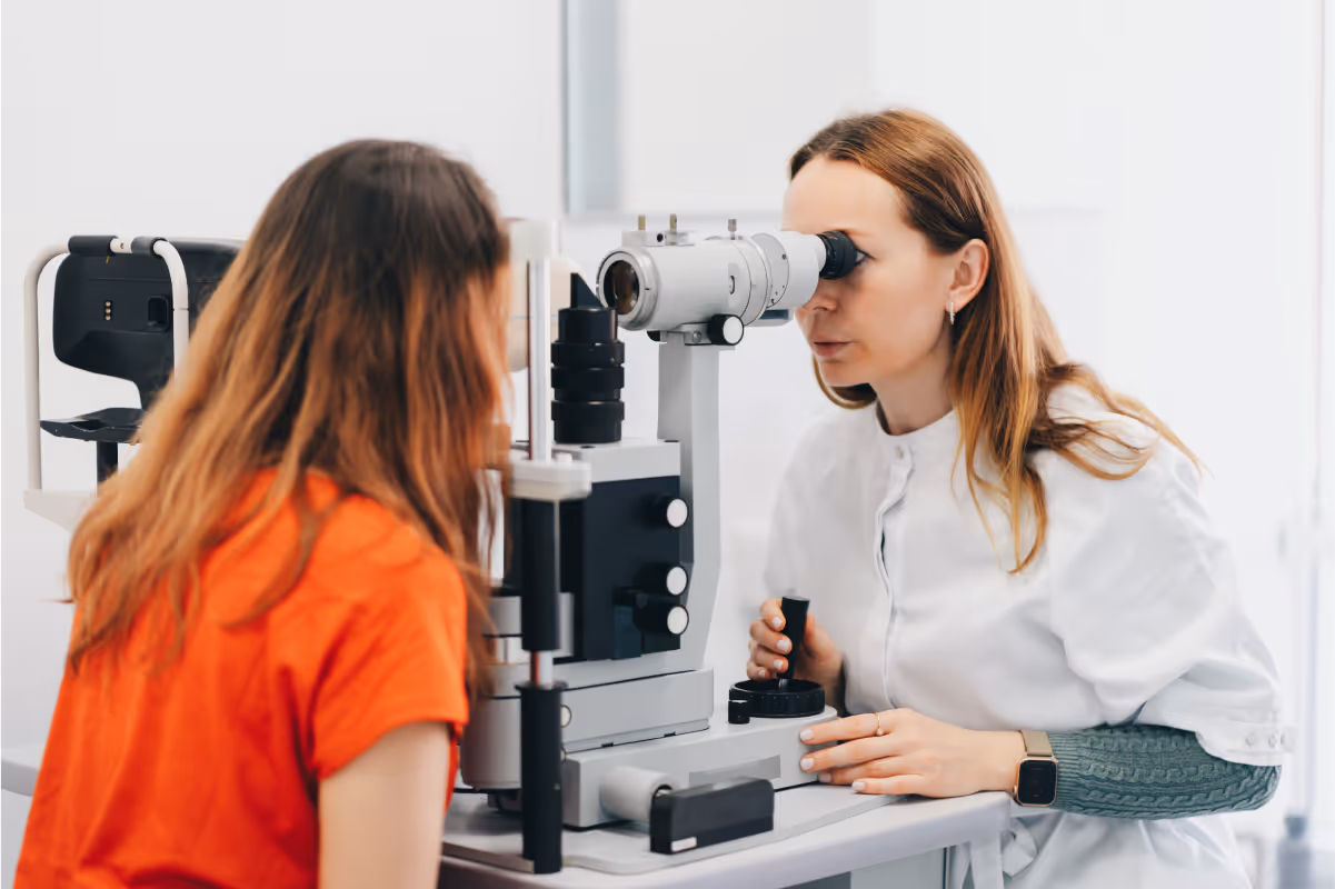 Eye Woman using advanced equipment to have her eyes tested