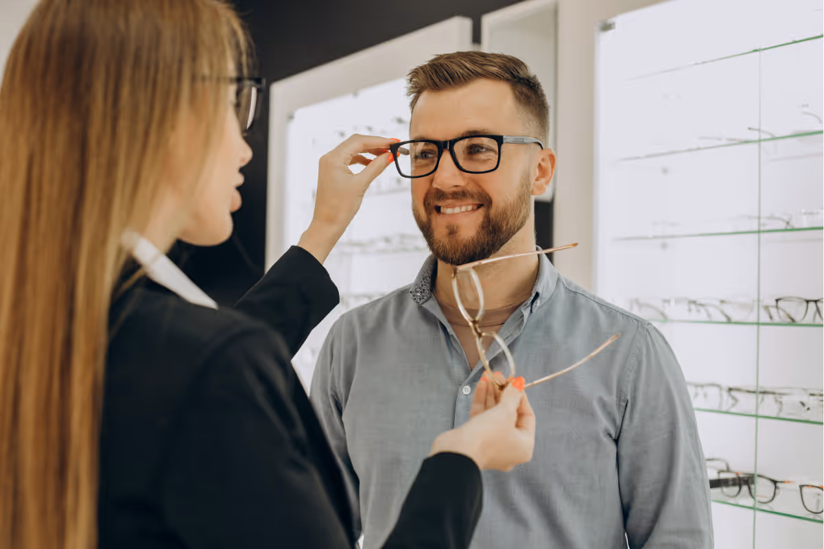 dispensing optician helping choose frames