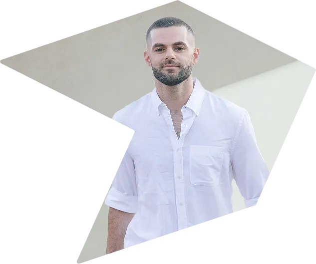 Franco, our CEO, stands in a white shirt in front of a light background.