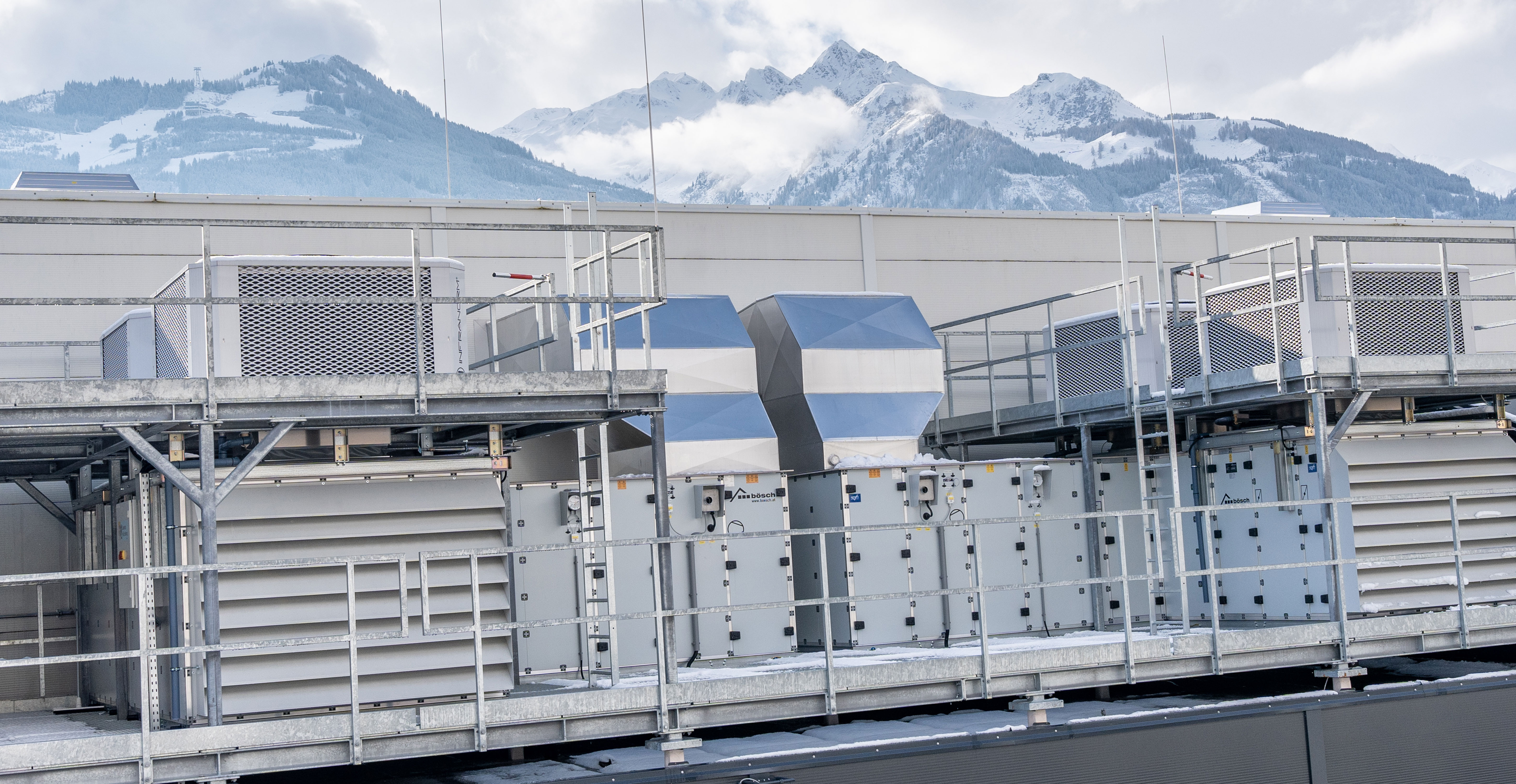 Two Infranorm workers work on the roof of a building