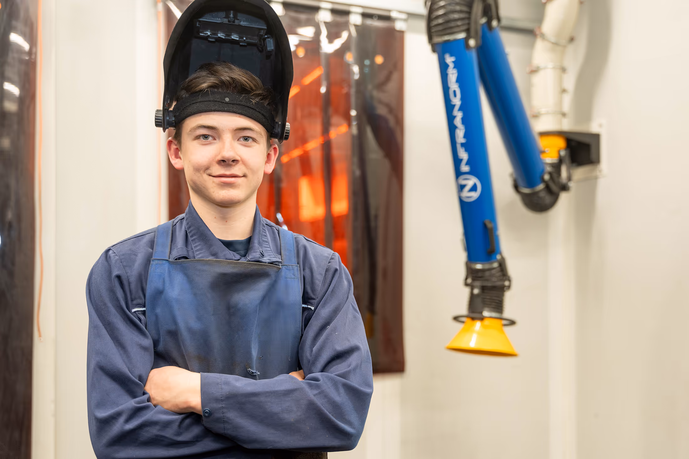Two Infranorm workers work on the roof of a building