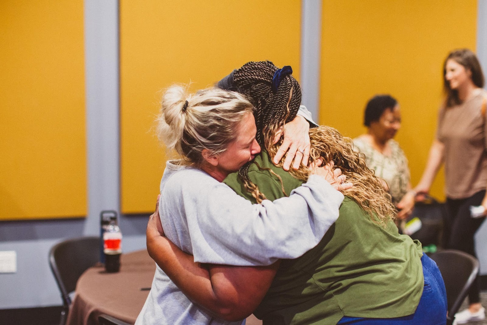 A group of women huggingAI-generated content may be incorrect.