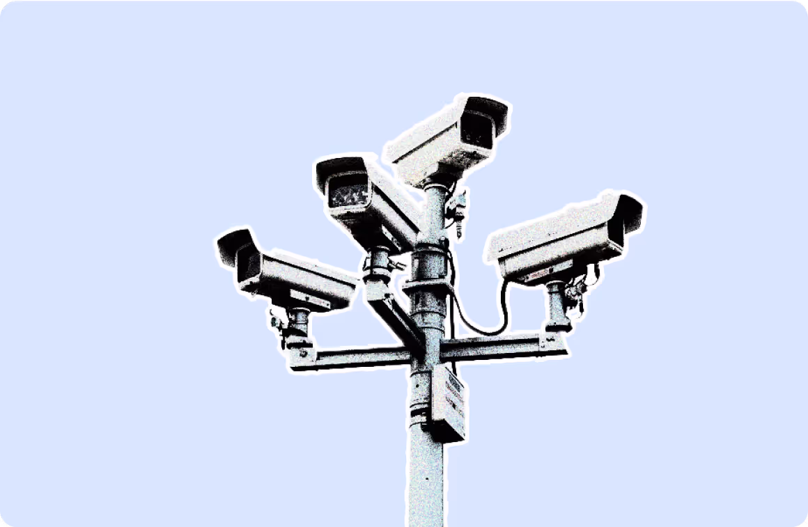 Multiple security cameras mounted on a pole.