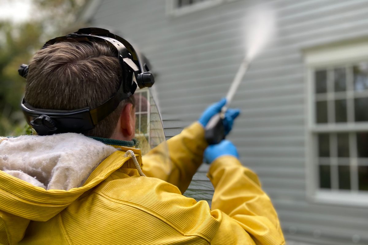 Pressure washing a home's exterior siding in Anderson, SC
