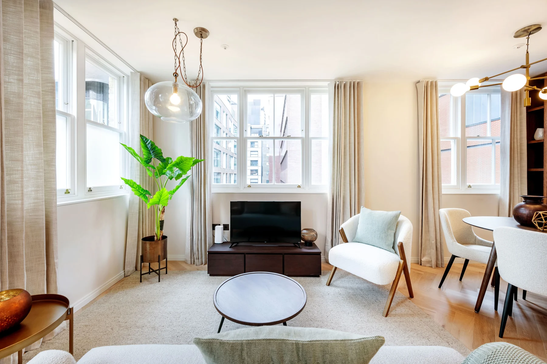 A light-filled Ellercove apartment with bay windows, soft furnishings and warm wood flooring