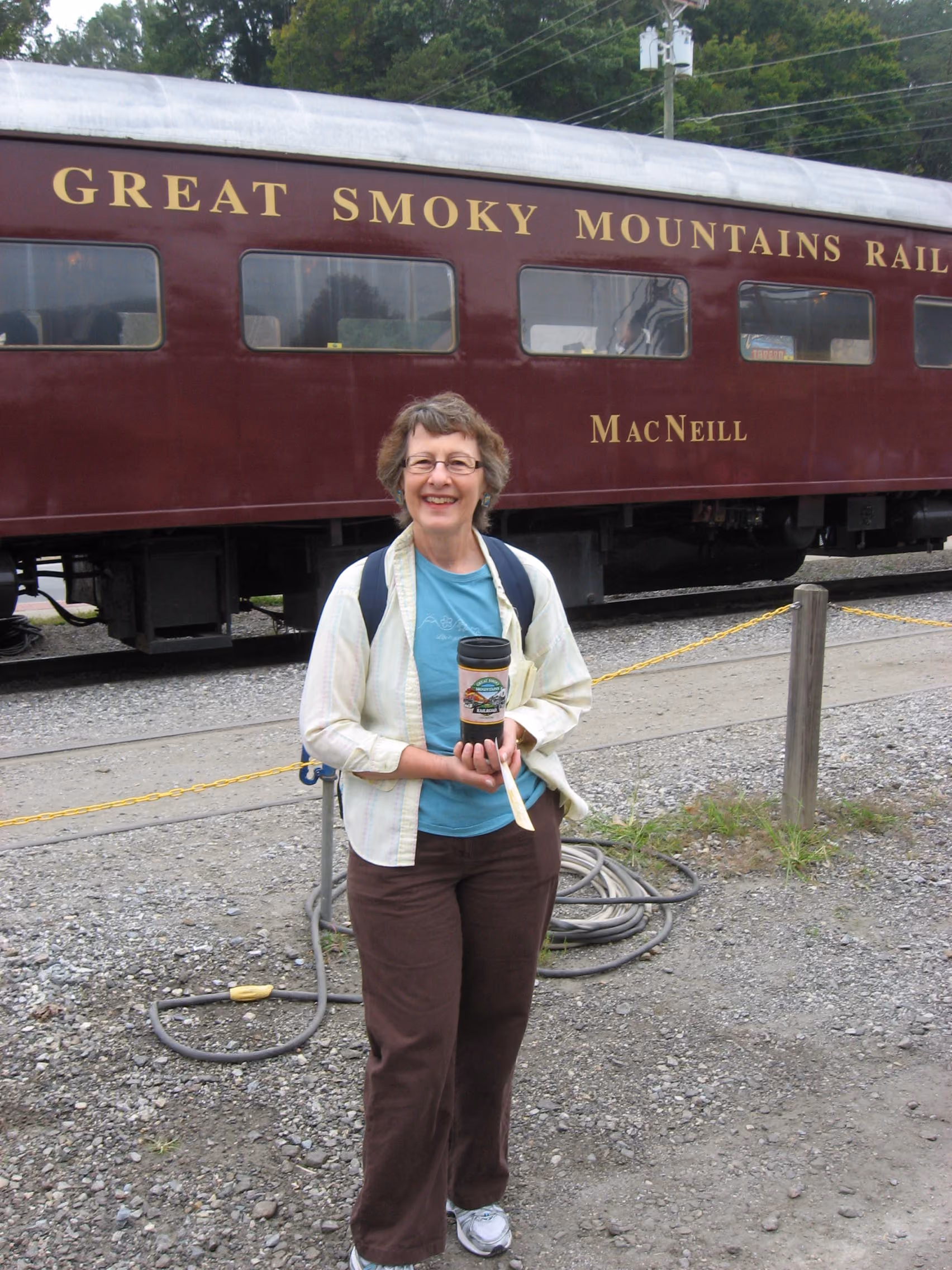 Bobbi in front of a Great Smoky Mountains Railroad train car