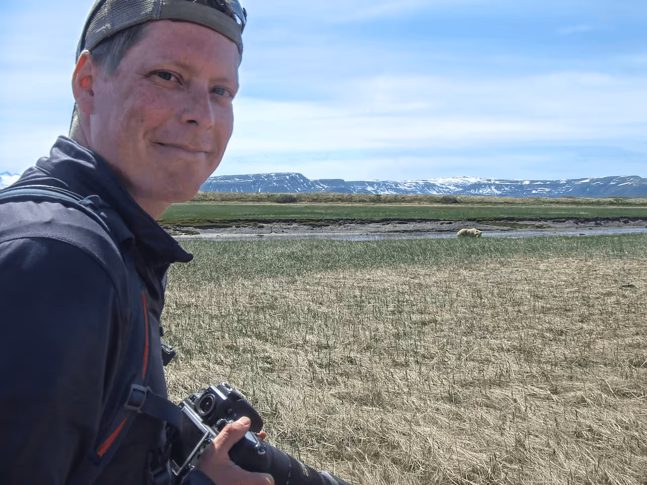 Brown bear at Katmai National Park in Alaska with photographer Ryan Pett nearby