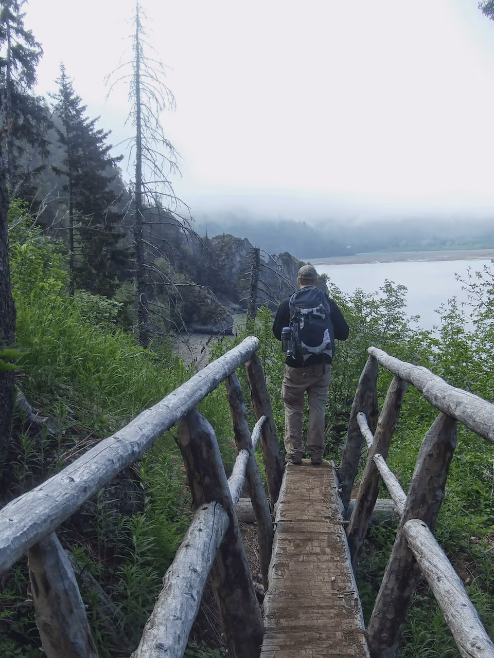 Ryan Pett on alpine trail above turquoise lake in Alaska wilderness