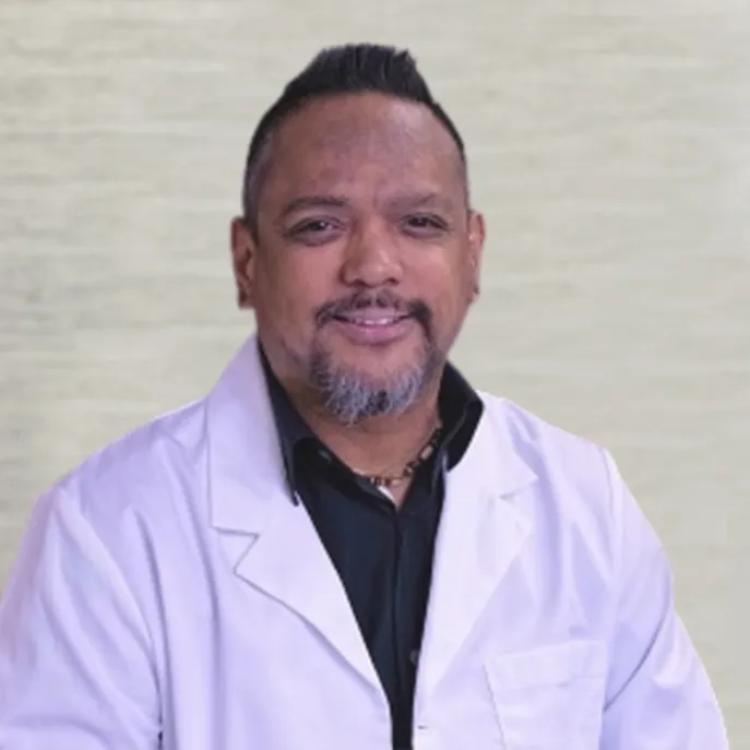 Portrait of Dr Marlowe Tanafranca smiling, wearing a white lab coat against a neutral background.